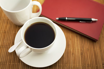 Fototapeta na wymiar a cup of coffee and a notebook