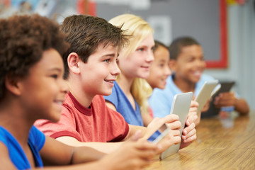 Pupils In Class Using Digital Tablet