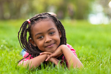 Outdoor portrait of a cute young black girl smiling - African pe