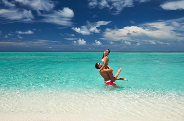 Fototapeta na wymiar Couple on a beach at Maldives