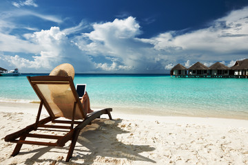 Young woman with tablet pc at the beach