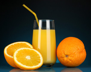 Delicious orange juice in glass and oranges next to it