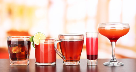 Several glasses of different drinks on bright background