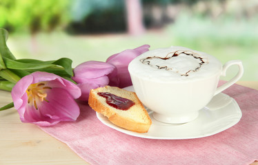 Composition of coffee, toast and tulips on bright background