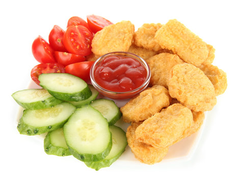 Fried chicken nuggets with sauce and vegetables isolated