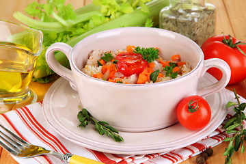Delicious rice with vegetables and herbs in pot