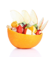 Fruit salad in hollowed-out orange isolated on white