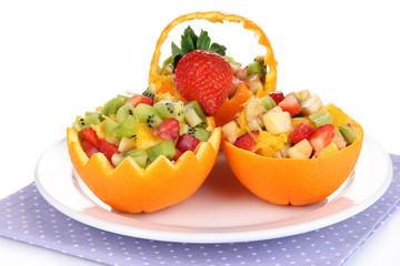 Naklejka na ściany i meble Fruit salad in hollowed-out orange isolated on white