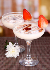 Fruit smoothies on table on window background