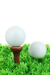 Golf balls on grass isolated on white