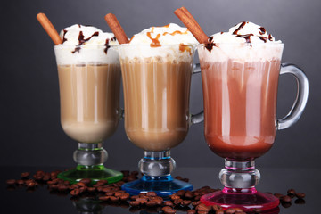 Layered coffee in glass on table on grey background