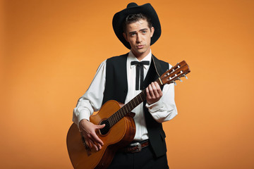 Naklejka premium Retro country male guitar player wearing black suit and hat. Stu