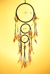 Beautiful dream catcher on yellow background