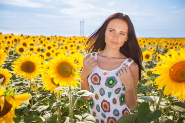 Beautiful young woman on the sunflowers field