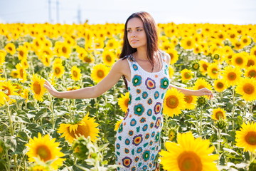 Beautiful young woman on the sunflowers field