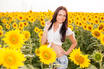 Beautiful young woman on the sunflowers field