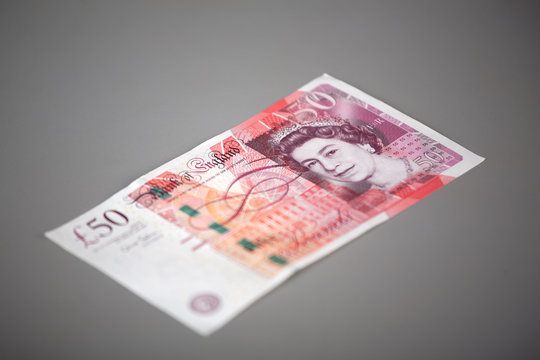 The Fifty Pounds Sterling. On A Gray Background