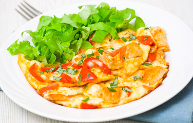 omelette with slices of chicken breast and vegetables