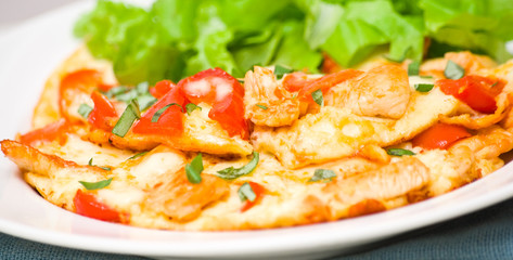 omelette with slices of chicken breast and vegetables