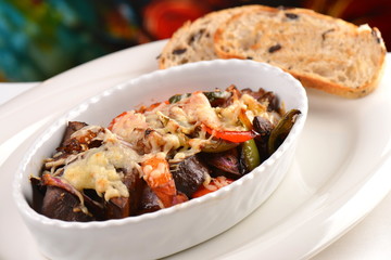 Ratatouille baked in the oven with a cheese and olives bread