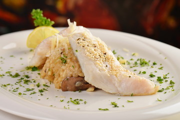 Prepared fillet of a white fish on Risotto with mushrooms