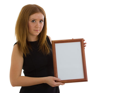 The lady is holding a wooden frame