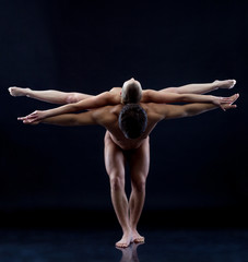Image of two naked acrobats showing trick