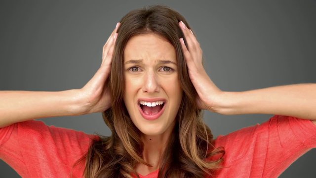 Frustrated woman holding her head between hands