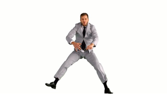 Businessman jumping and doing the splits