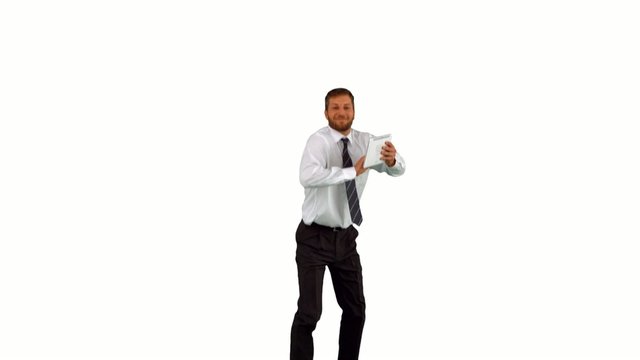 Businessman jumping up holding tablet