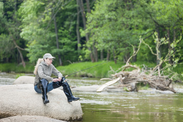 woman fishing in Sazava river, Czech Republic