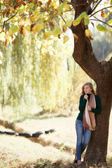 Beautiful young woman in autumn park