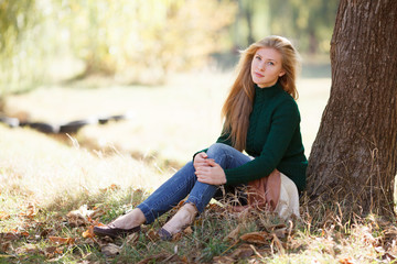 Beautiful young woman in autumn park