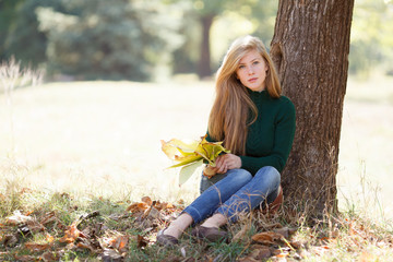 Beautiful young woman in autumn park