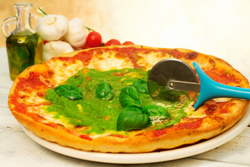 pizza with pesto sauce and ingredients