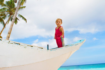 outdoor portrait of happy baby child on board of sea boat