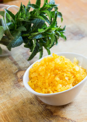 Sea salt in bowl on wooden background