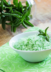 Sea salt in bowl on wooden background