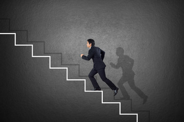 Obraz premium business man climbing on stairs 