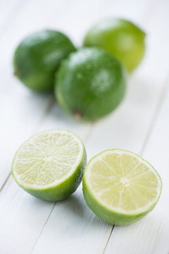 Fruits: fresh ripe limes on wooden boards