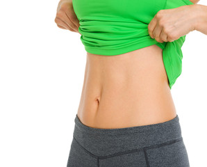 Fototapeta premium Closeup on tummy of fitness woman