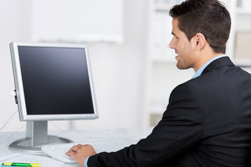 geschäftsmann schaut auf seinen monitor