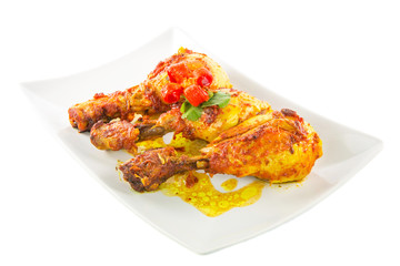 Tandoori chicken in a plate over white background