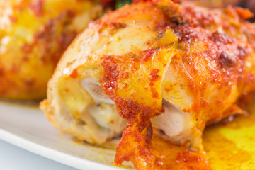 Tandoori chicken in a plate over white background