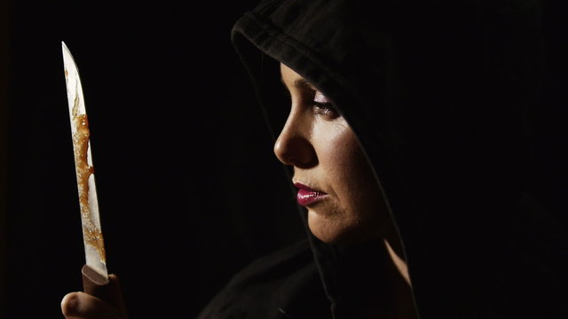 Black woman with knife in the dark