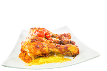 Tandoori chicken in a plate over white background
