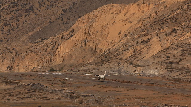 Airplane take off from Jomsom airport in Himalayas.