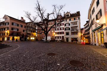 Fototapeta na wymiar Illuminated Square near Saint Peter Church in the Evening, Zuric