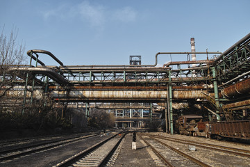 Fototapeta premium Rusted railway and abandoned steelmaking equipments