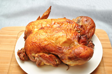 Whole Roasted Chicken on a White Serving Plate